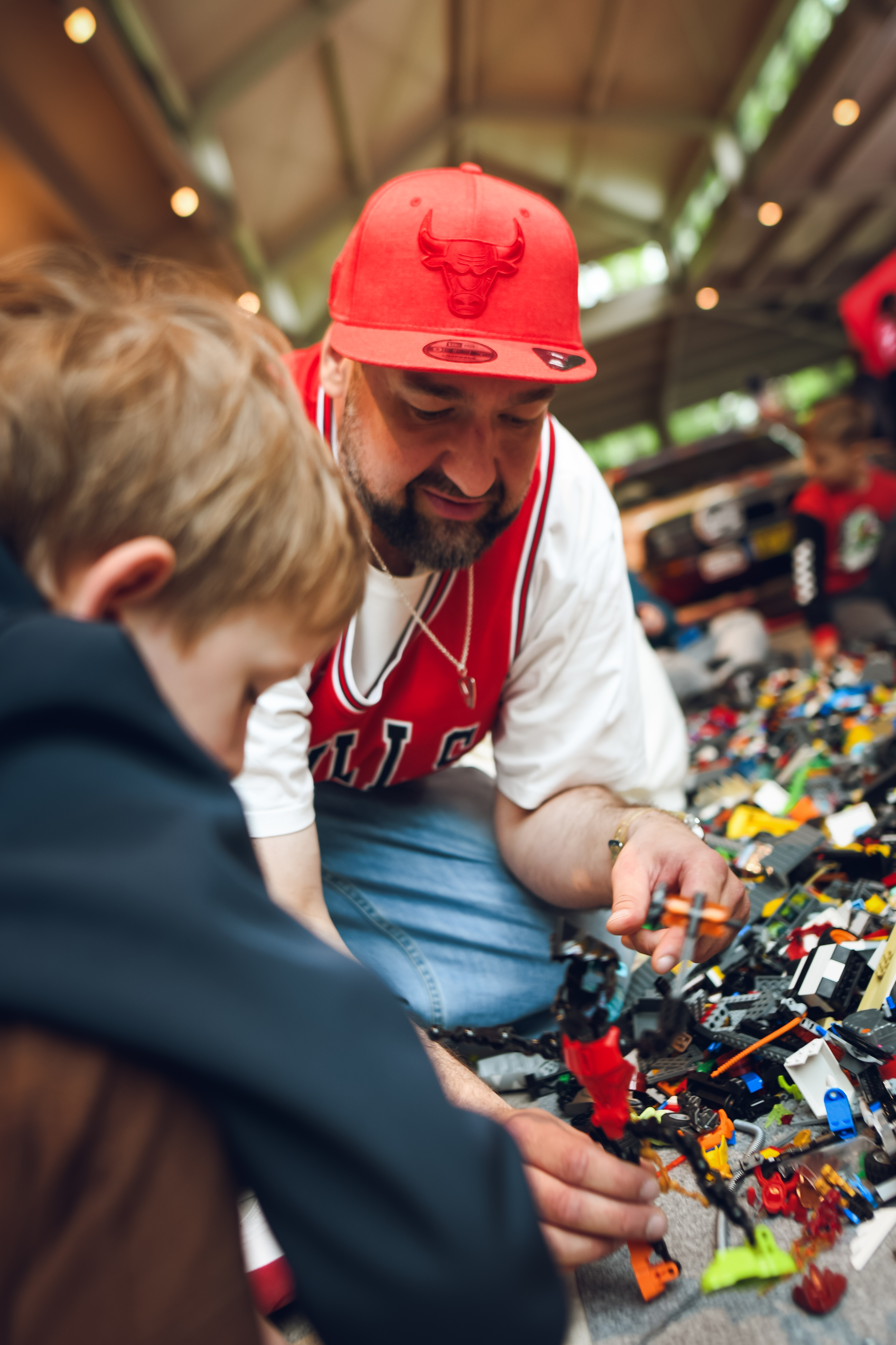 Child and adult building LEGO together