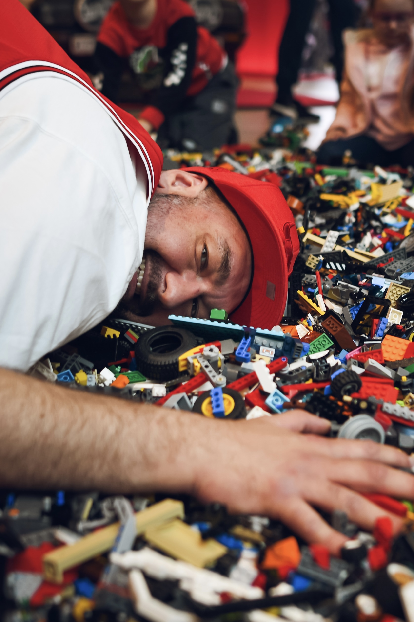 Hands building a complex LEGO construction